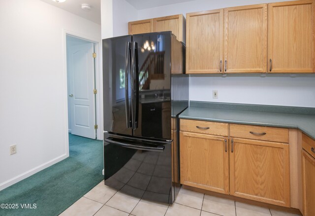 205 Crazy Horse Pt Unit 205, Edwards, CO 81632 - kitchen with freestanding refrigerator, light colored carpet, and light tile patterned floors