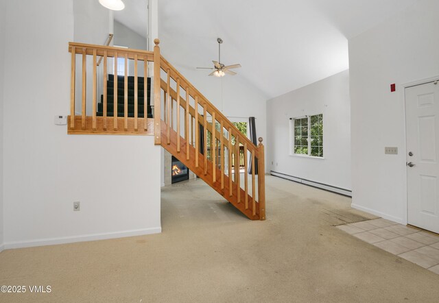 205 Crazy Horse Pt Unit 205, Edwards, CO 81632 - entrance foyer featuring a baseboard heating unit, a ceiling fan, carpet floors, high vaulted ceiling, and stairs