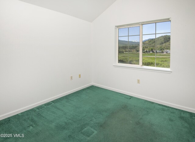 205 Crazy Horse Pt Unit 205, Edwards, CO 81632 - carpeted empty room featuring vaulted ceiling and a mountain view