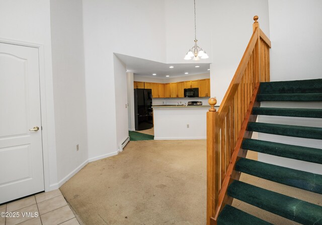 205 Crazy Horse Pt Unit 205, Edwards, CO 81632 - stairway featuring a chandelier, a baseboard heating unit, carpet flooring, recessed lighting, and a towering ceiling