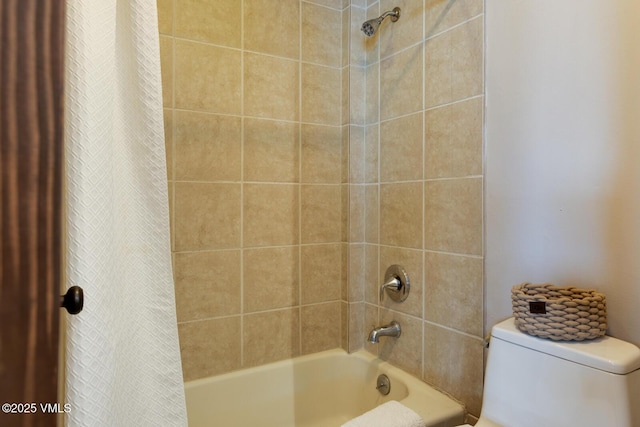 full bathroom featuring shower / bath combo with shower curtain and toilet