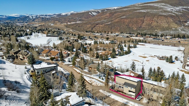 snowy aerial view featuring a mountain view