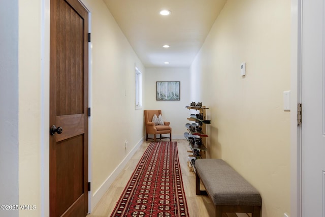 hall with recessed lighting and baseboards