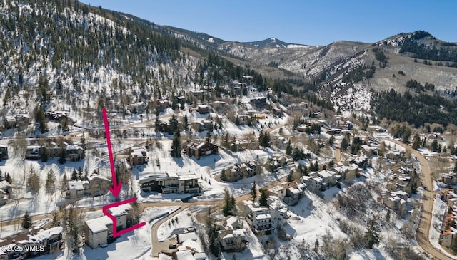 snowy aerial view with a mountain view