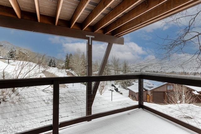 view of snow covered back of property