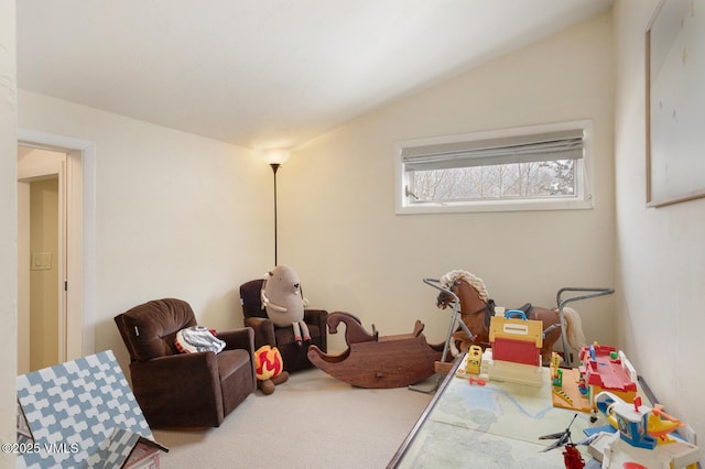 rec room with carpet floors and vaulted ceiling