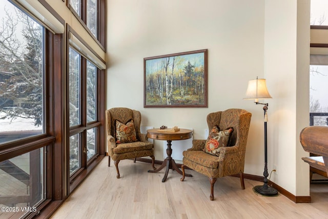 sitting room with light wood-type flooring and baseboards