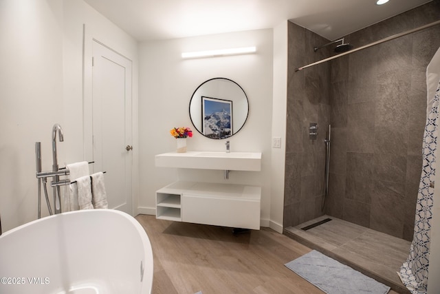 710 W Lionshead Cir Unit 115, Vail, CO 81657 - full bath featuring wood finished floors, tiled shower, and a freestanding tub