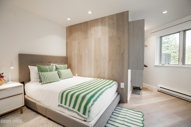 710 W Lionshead Cir Unit 115, Vail, CO 81657 - bedroom featuring a baseboard heating unit, wood finished floors, recessed lighting, and radiator heating unit