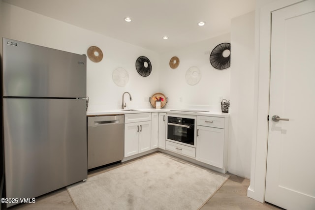 710 W Lionshead Cir Unit 115, Vail, CO 81657 - kitchen featuring black appliances, white cabinetry, light countertops, recessed lighting, and light wood-style floors