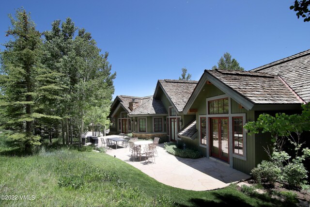 rear view of house with french doors and a patio