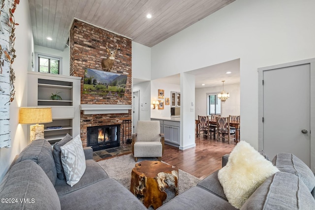 living room featuring dark hardwood / wood-style flooring, wood ceiling, a fireplace, and a high ceiling