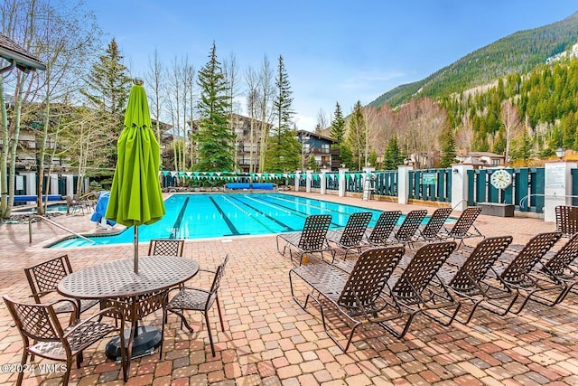 view of pool with a mountain view and a patio area