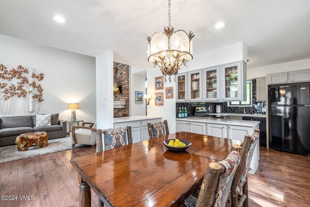 dining area with an inviting chandelier and light wood-type flooring