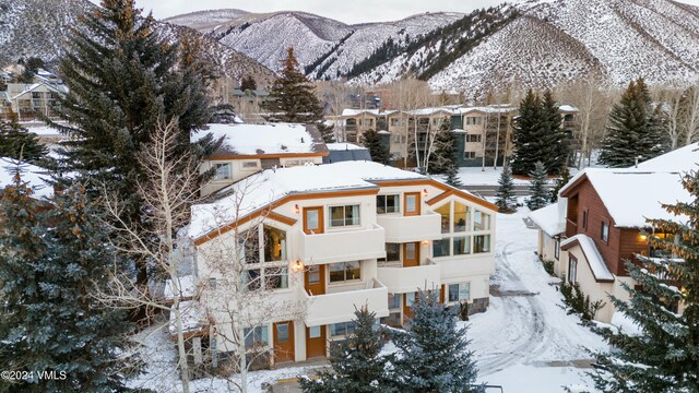 snowy aerial view featuring a mountain view