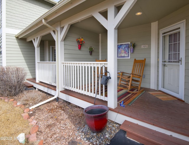 view of exterior entry with a porch