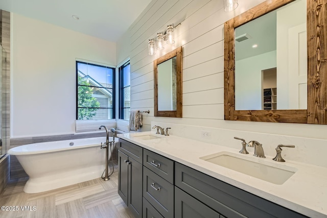 146 Robins Egg Ln, Eagle, CO 81631 - bathroom featuring a soaking tub, double vanity, and wooden walls