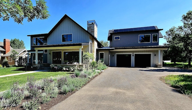 146 Robins Egg Ln, Eagle, CO 81631 - view of front of home featuring a chimney, driveway, board and batten siding, a front yard, and an attached garage