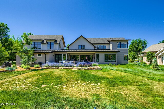 146 Robins Egg Ln, Eagle, CO 81631 - rear view of property featuring a standing seam roof, a lawn, a metal roof, board and batten siding, and a shingled roof