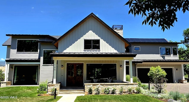 146 Robins Egg Ln, Eagle, CO 81631 - modern inspired farmhouse featuring a standing seam roof, a metal roof, a chimney, and a garage