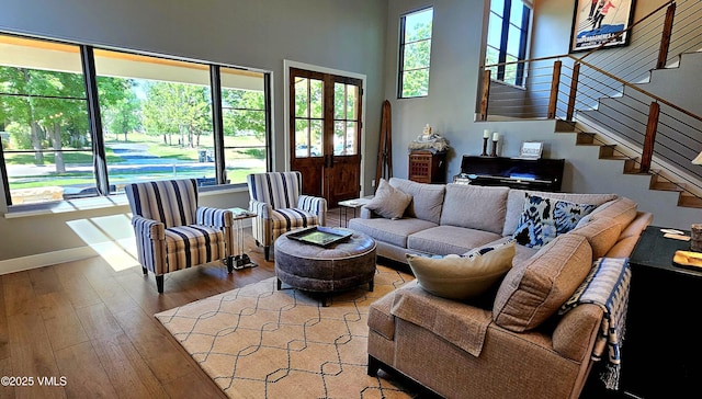 146 Robins Egg Ln, Eagle, CO 81631 - living room with stairs, wood-type flooring, a high ceiling, and french doors