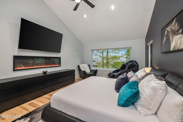 5780 Wildridge Rd E Unit A, Avon, CO 81620 - bedroom featuring wood finished floors, lofted ceiling, a glass covered fireplace, ceiling fan, and recessed lighting