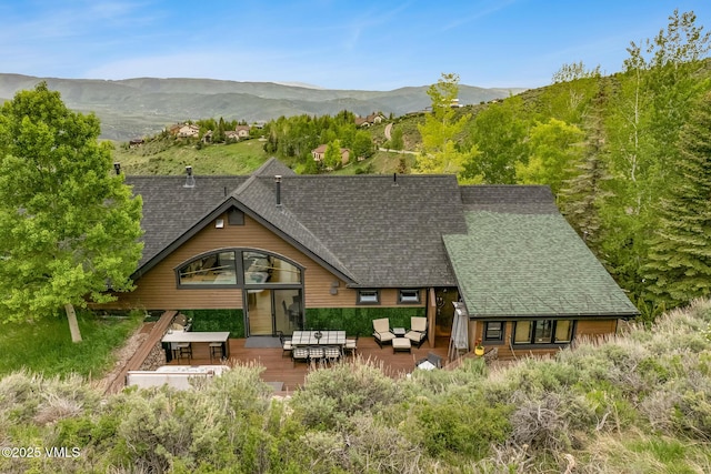 5780 Wildridge Rd E Unit A, Avon, CO 81620 - view of front of house with an outdoor hangout area, roof with shingles, and a deck with mountain view