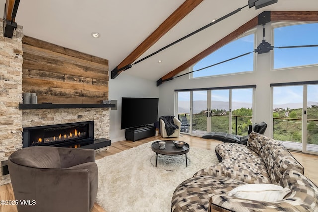 5780 Wildridge Rd E Unit A, Avon, CO 81620 - living room with beam ceiling, a stone fireplace, wood finished floors, and high vaulted ceiling