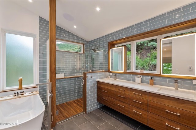 5780 Wildridge Rd E Unit A, Avon, CO 81620 - full bath with tile walls, tile patterned floors, a shower stall, double vanity, and a soaking tub