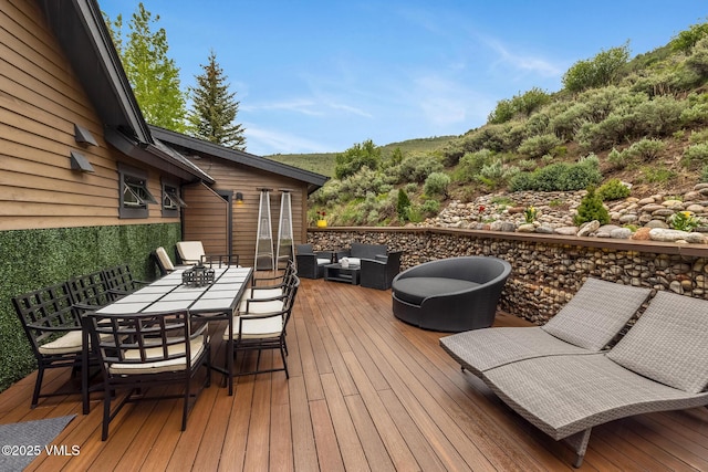 5780 Wildridge Rd E Unit A, Avon, CO 81620 - wooden deck with outdoor lounge area and outdoor dining area