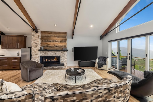 5780 Wildridge Rd E Unit A, Avon, CO 81620 - living area featuring beamed ceiling, light wood-style floors, and a fireplace