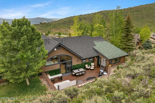5780 Wildridge Rd E Unit A, Avon, CO 81620 - rear view of house with a deck with mountain view, a shingled roof, and an outdoor living space