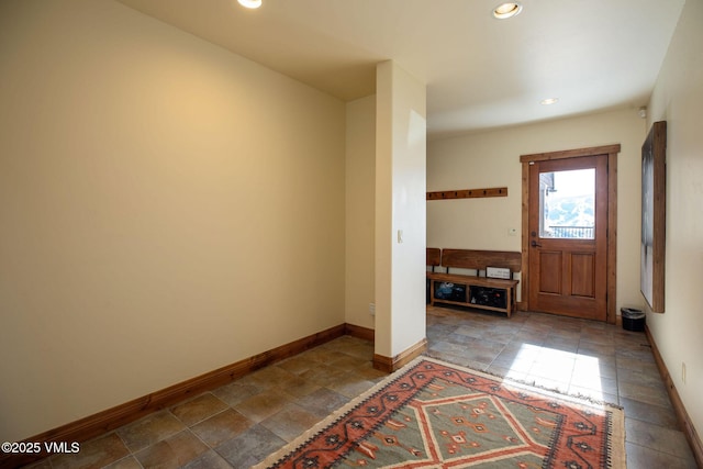 entryway with baseboards and recessed lighting