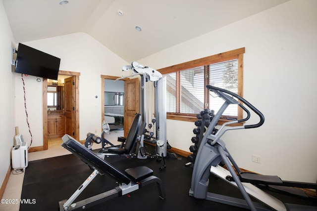 workout area with vaulted ceiling and baseboards