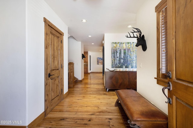 hallway with light wood-style floors, recessed lighting, and baseboards