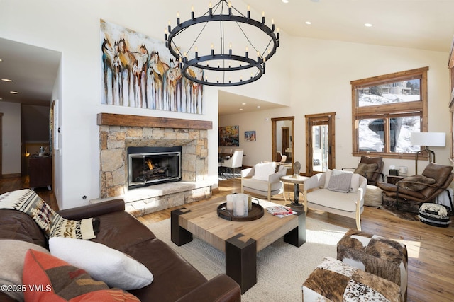 living area with recessed lighting, a fireplace, a notable chandelier, and wood finished floors