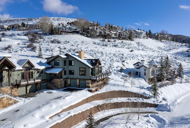 snowy aerial view with a residential view