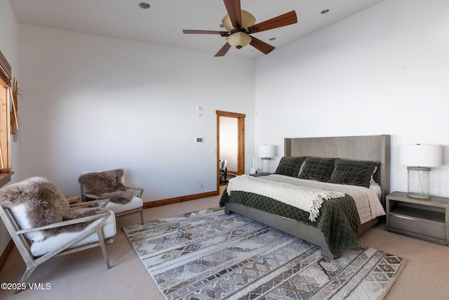 carpeted bedroom featuring high vaulted ceiling, a ceiling fan, and baseboards