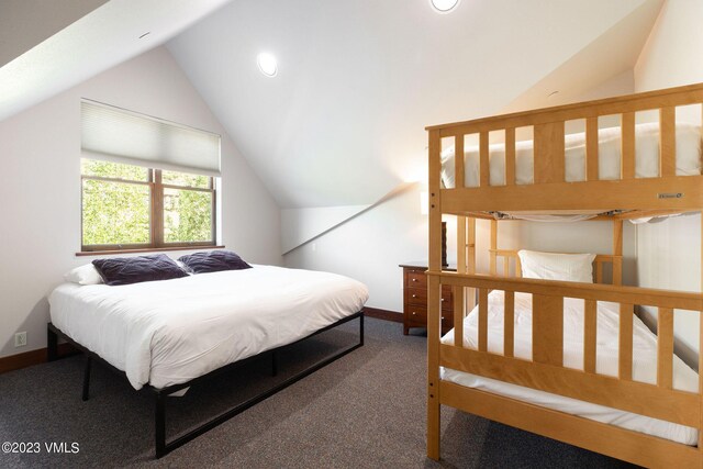 carpeted bedroom with vaulted ceiling