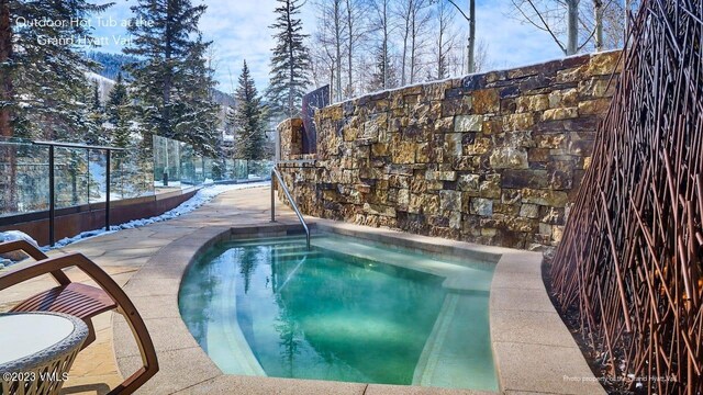 snow covered pool with a patio area