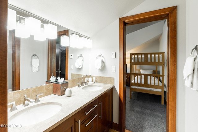 bathroom featuring vanity and lofted ceiling