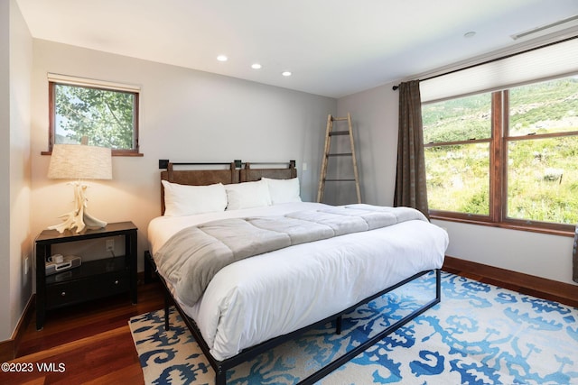 bedroom with dark hardwood / wood-style floors