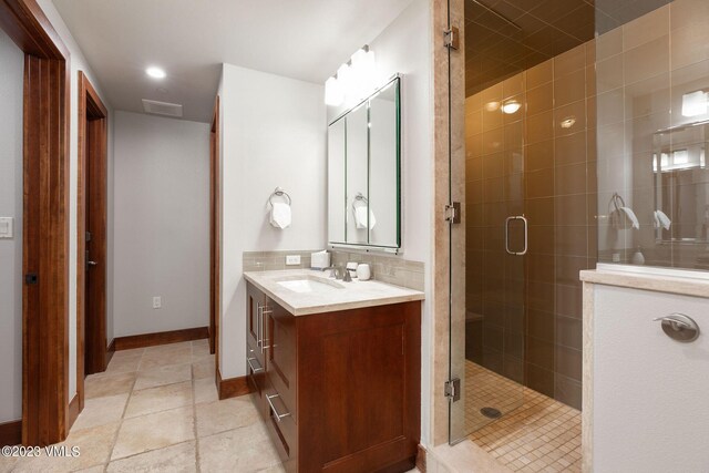 bathroom featuring walk in shower, vanity, and tile patterned flooring