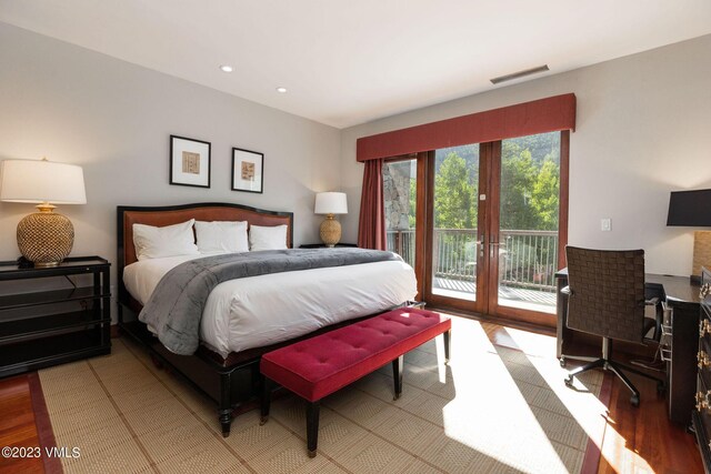 bedroom with access to outside, light hardwood / wood-style floors, and french doors