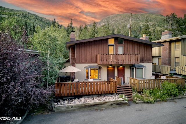 4254 Columbine Way Unit 9, Vail, CO 81657 - view of front of property with a chimney, a mountain view, a balcony, a view of trees, and a porch