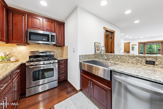 4254 Columbine Way Unit 9, Vail, CO 81657 - kitchen with stainless steel appliances, dark wood-style floors, recessed lighting, backsplash, and light stone countertops