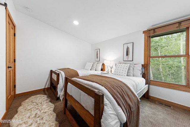 4254 Columbine Way Unit 9, Vail, CO 81657 - carpeted bedroom with lofted ceiling, a barn door, and recessed lighting