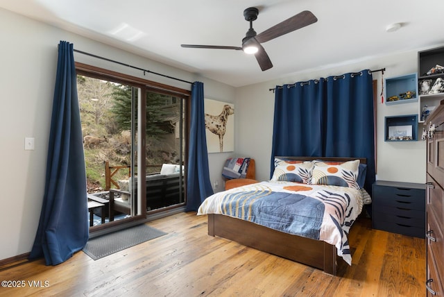 bedroom featuring access to outside, wood finished floors, and a ceiling fan