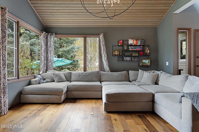 living area with lofted ceiling, wooden ceiling, a chandelier, and light wood-style floors