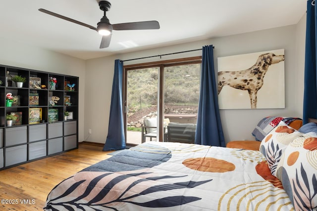 bedroom with access to outside, wood finished floors, and ceiling fan